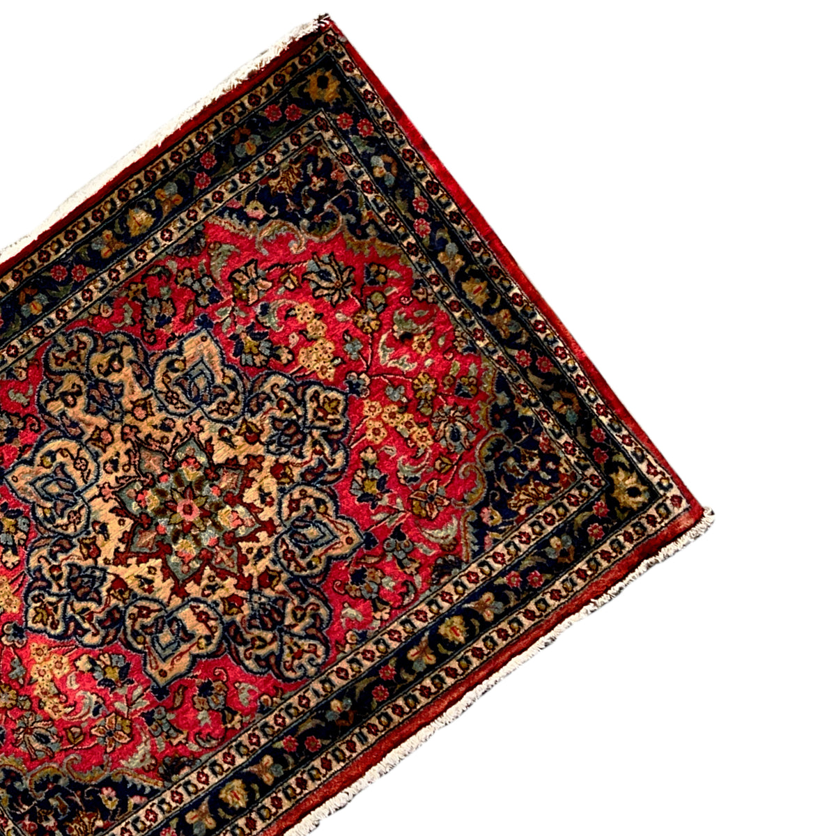 Carpet in oblique view with a red central medallion and dark blue border pattern