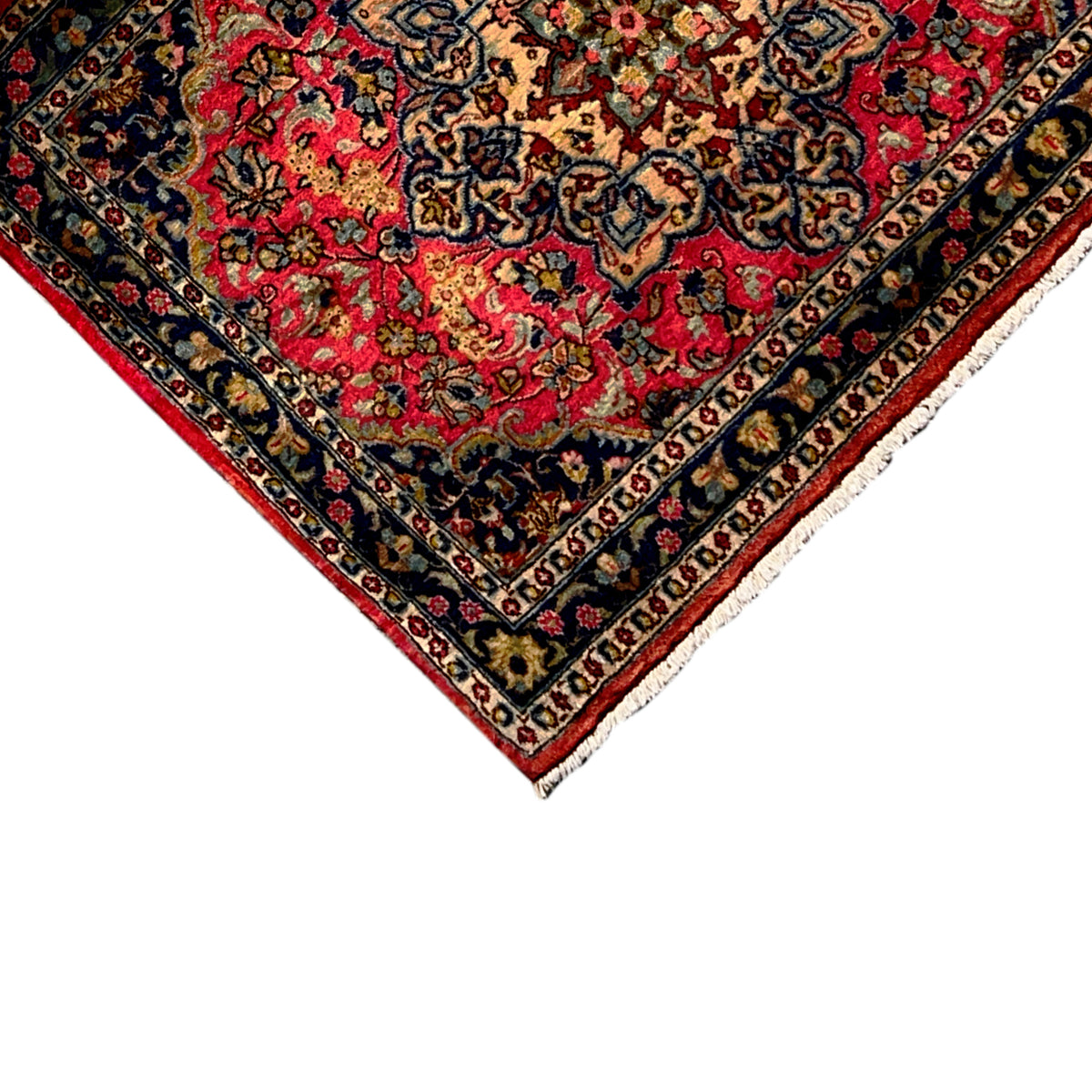 Carpet corner with decorative border, red background, and white edge trim