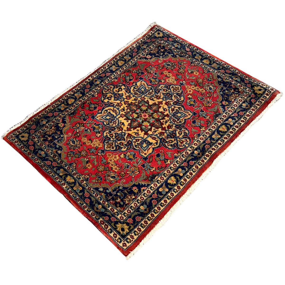Diamond-shaped rug: red central ornament, dark blue border, white edges