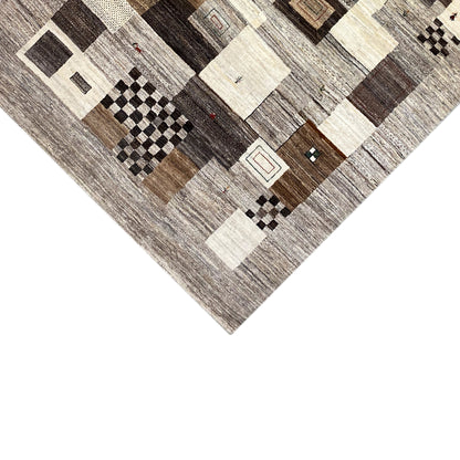 Gabbeh rug detail: checkerboard and square patterns in gray and cream