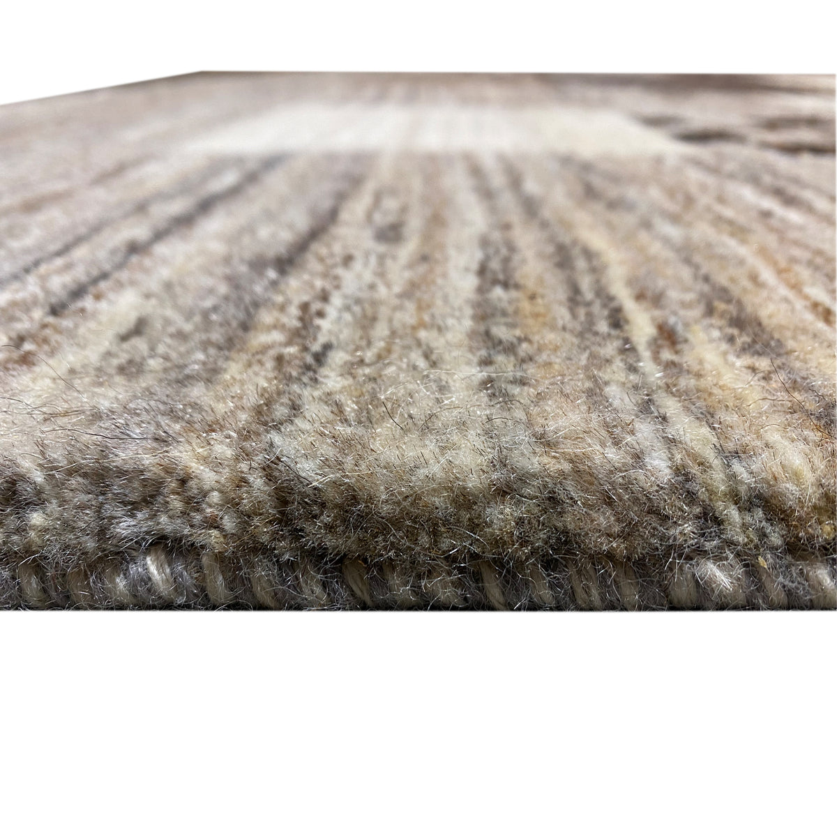 Gabbeh rug close-up of the pile texture, mottled in gray and beige
