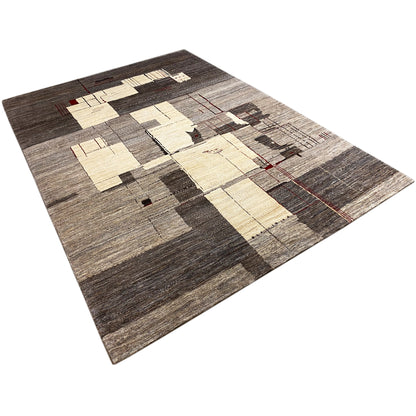 Gabbeh rug laid at an angle with a patchwork pattern in gray and beige with red accents