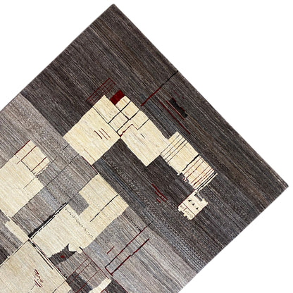 Gabbeh rug detail: dark border, light blocks, and red lines in the weave