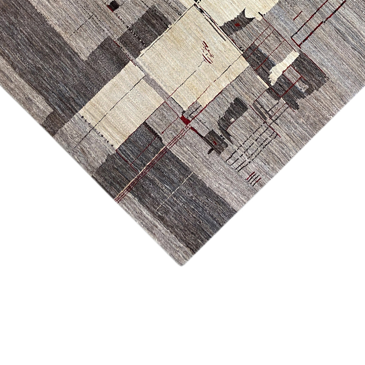 Gabbeh rug detail with light squares, a gray background, and fine red lines