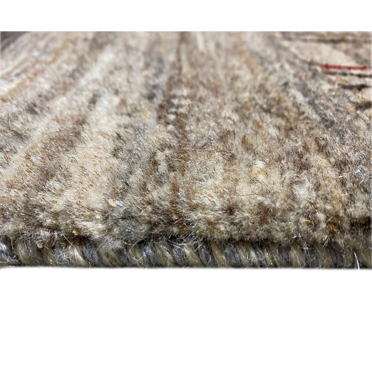 Gabbeh rug pile view with a mottled surface in beige and gray tones