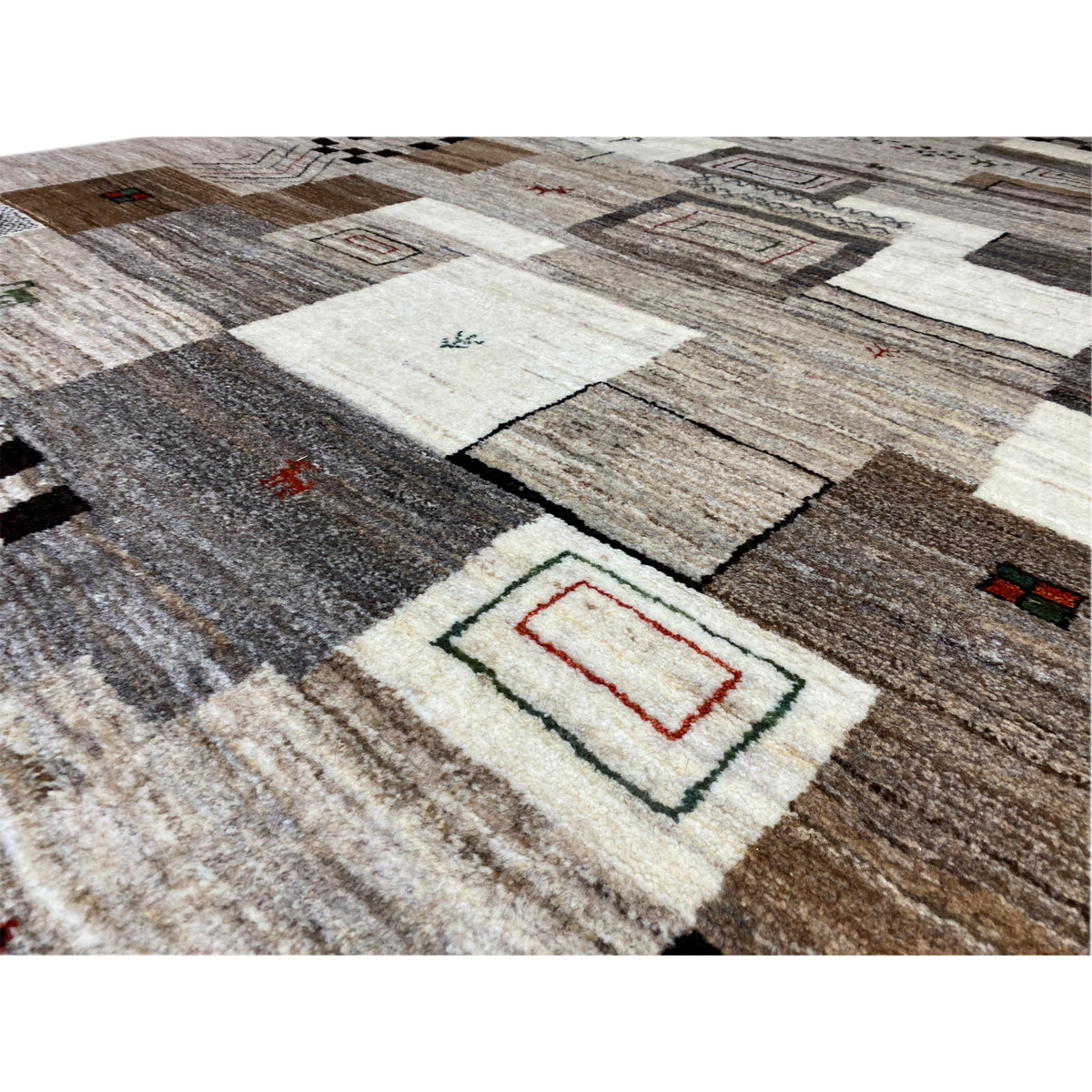 Close-up: carpet pile with woven patterns in gray, beige, black, and red