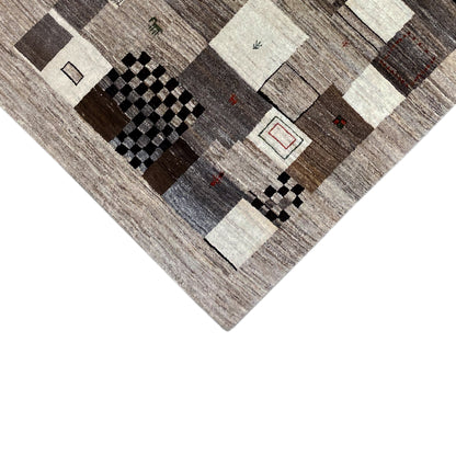 Carpet corner with black diamonds, beige and gray patchwork elements, fine woven texture