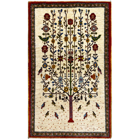 Gabbeh rug with a beige background, red border, and tree floral pattern in blue and red
