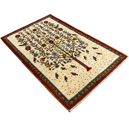 Rectangular Gabbeh rug with a beige base, red border, and medium tree-vine pattern