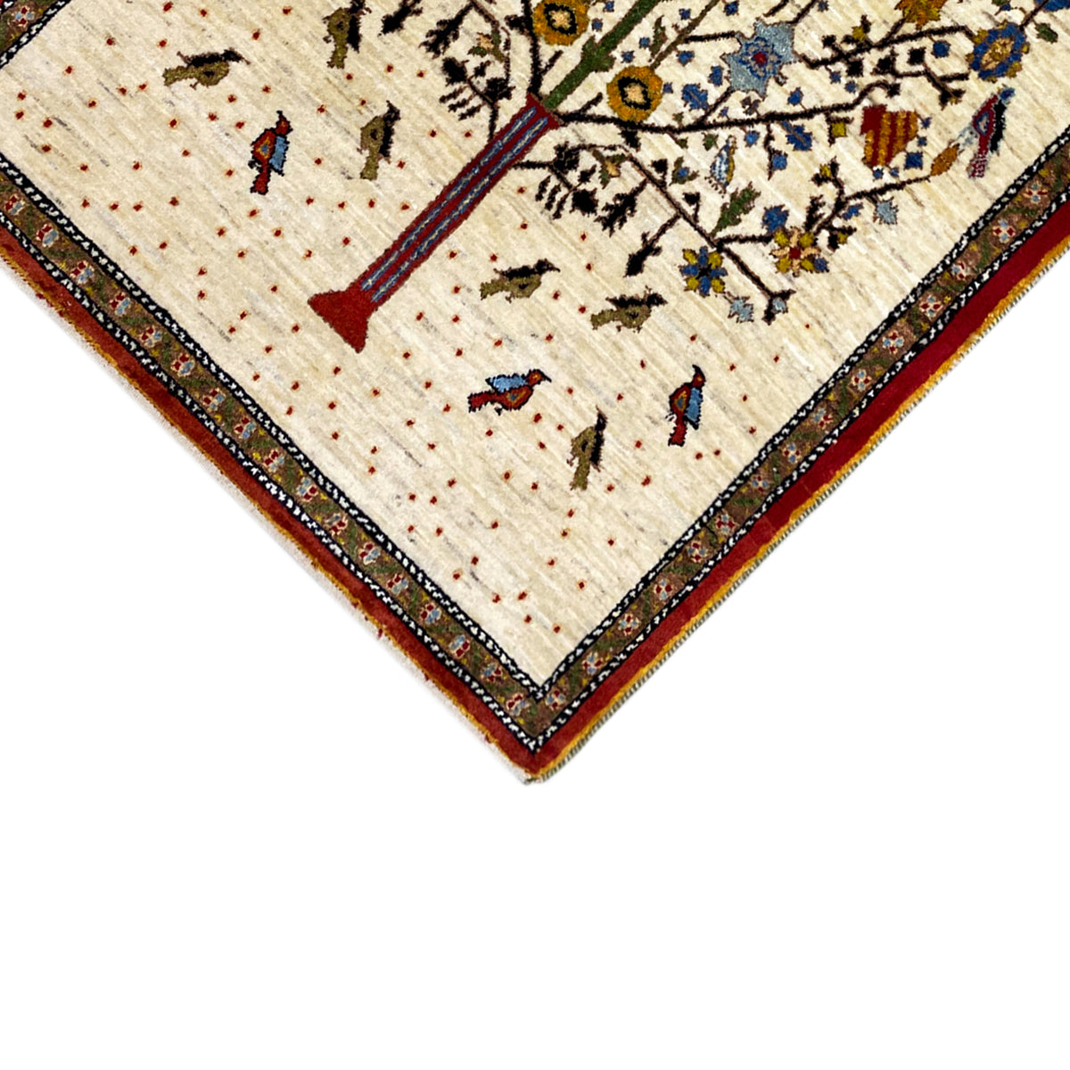 Corner view: Gabbeh rug with a red border, beige background, and colorful small motifs