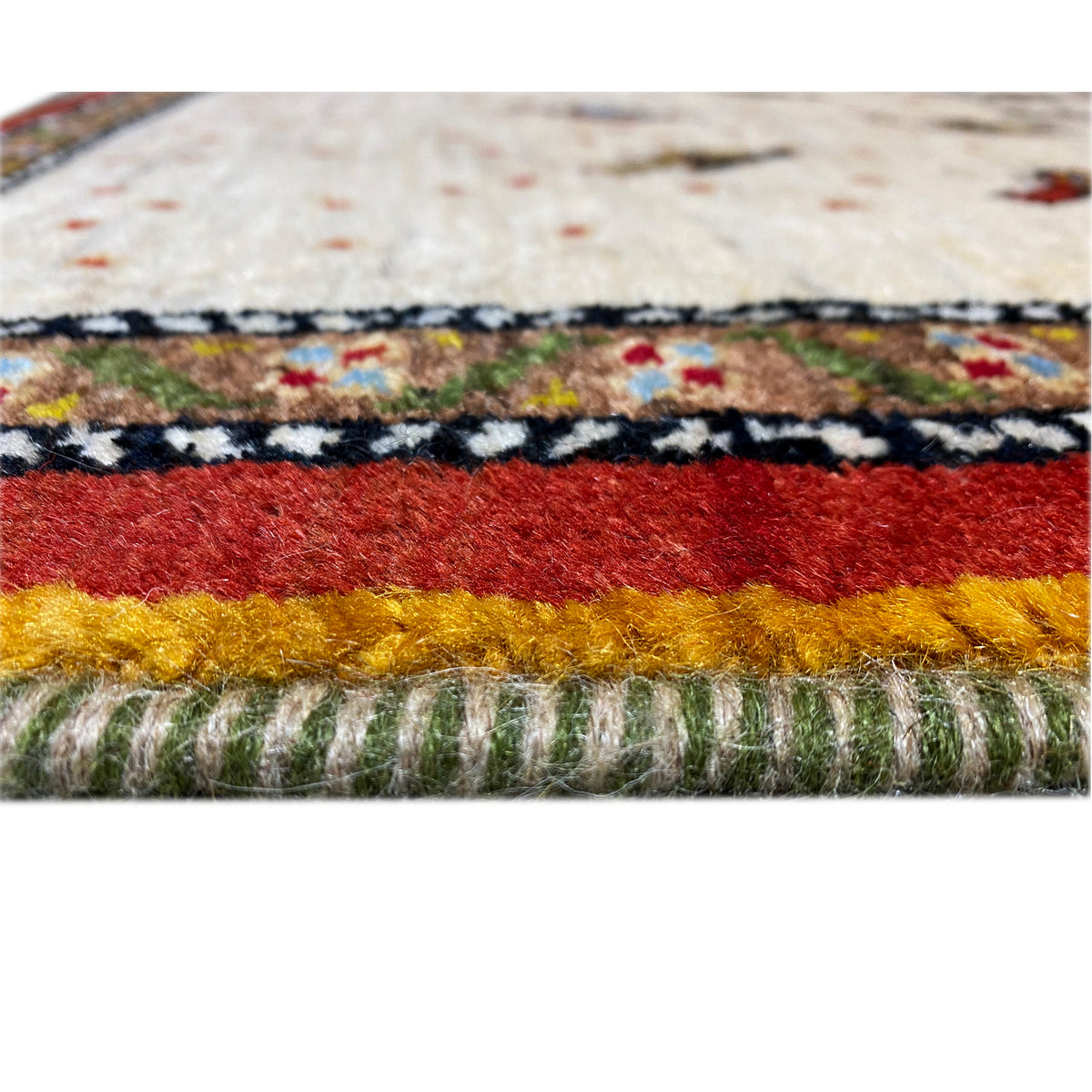 Rug edge with a multicolored finishing border and visible fringed border edge