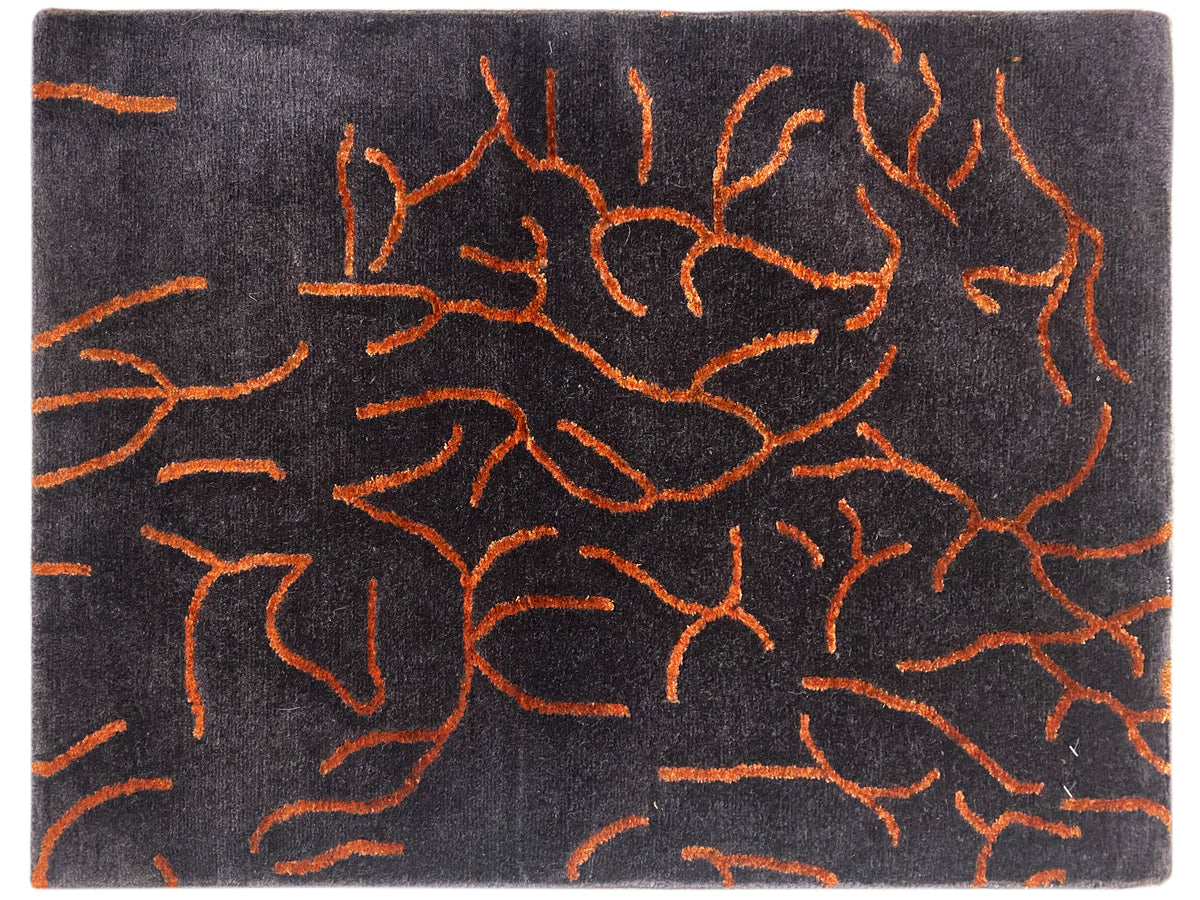 Designer rug in dark gray with an abstract orange line pattern, rectangular
