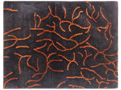 Designer rug in dark gray with an abstract orange line pattern, rectangular