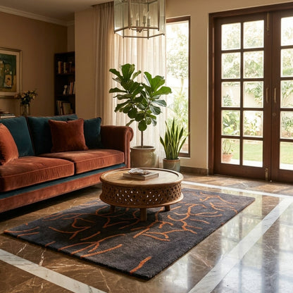 Designer rug in dark gray with an orange abstract line pattern in the living room