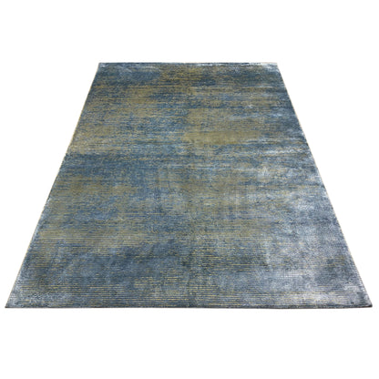 Designer rug with a blue-gray area pattern and golden horizontal stripes