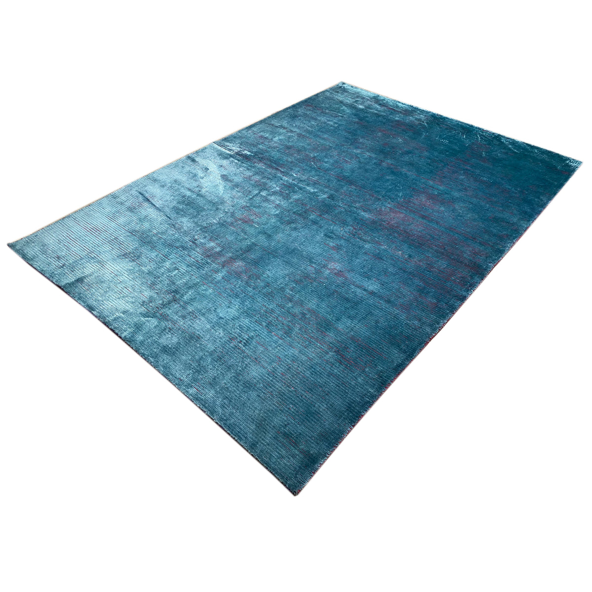 Designer rug in blue with a fine, matte woven texture and abstract color transitions