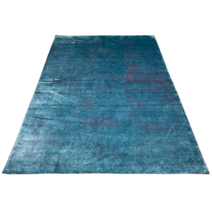 Designer rug in blue with an all-over pattern and a distressed vintage look