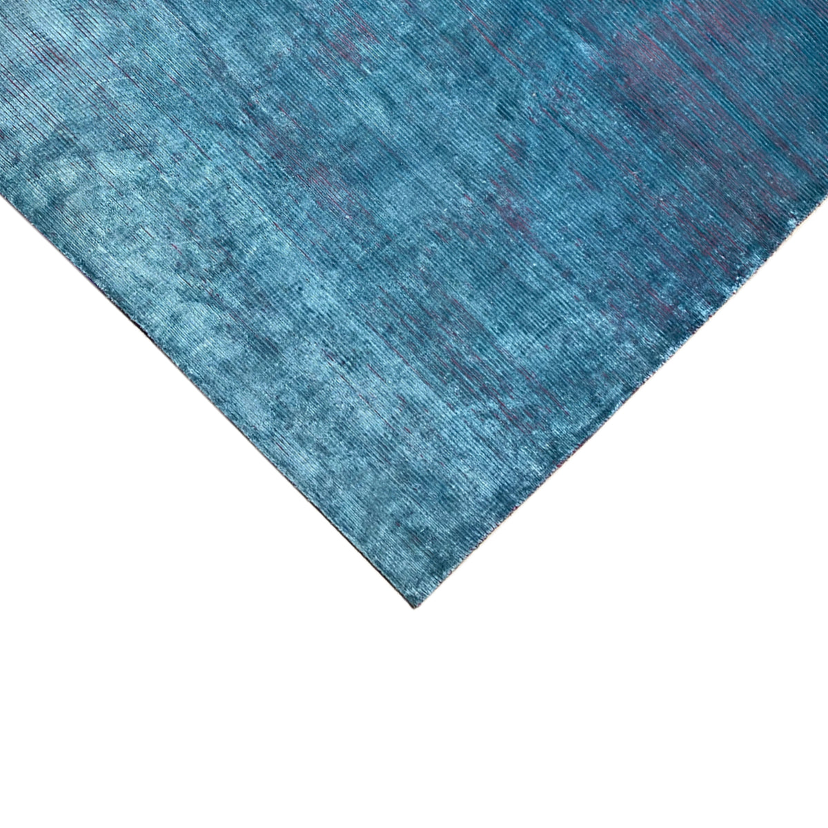 Designer rug Ecke in blue with a matte texture and fine color flecks
