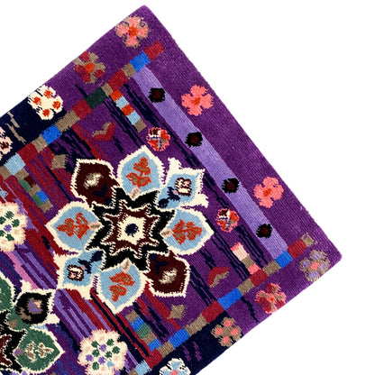 Carpet 77x62 cm corner with purple border and multicolored medallions