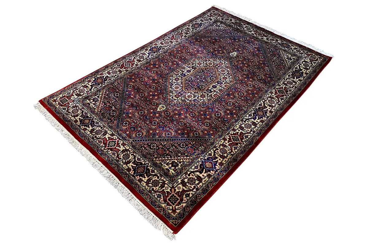 Bidjar carpet in diagonal view, blue-red medallion and high-contrast borders