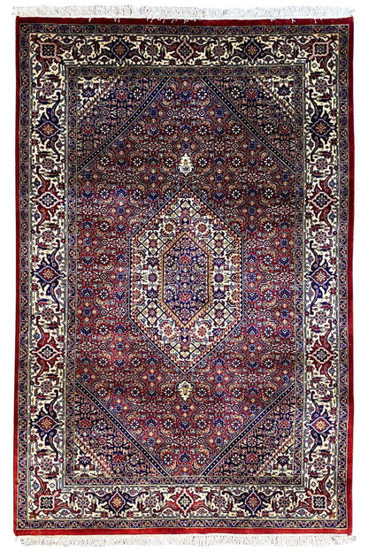Bidjar rug, rectangular shape, with a red background, blue medallion, and decorative borders