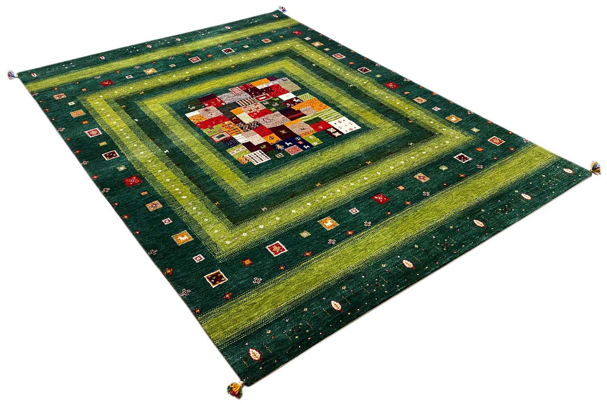 Gabbeh Lori rug in diagonal view with centered patchwork motif and vine border