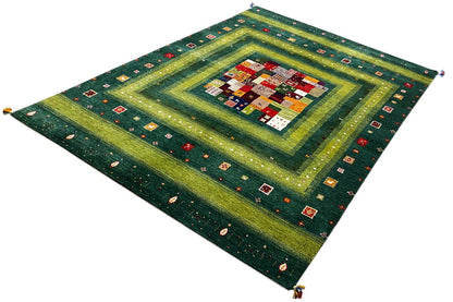 Gabbeh Lori rug photographed at an angle with a green-and-yellow square pattern and decorative stripes