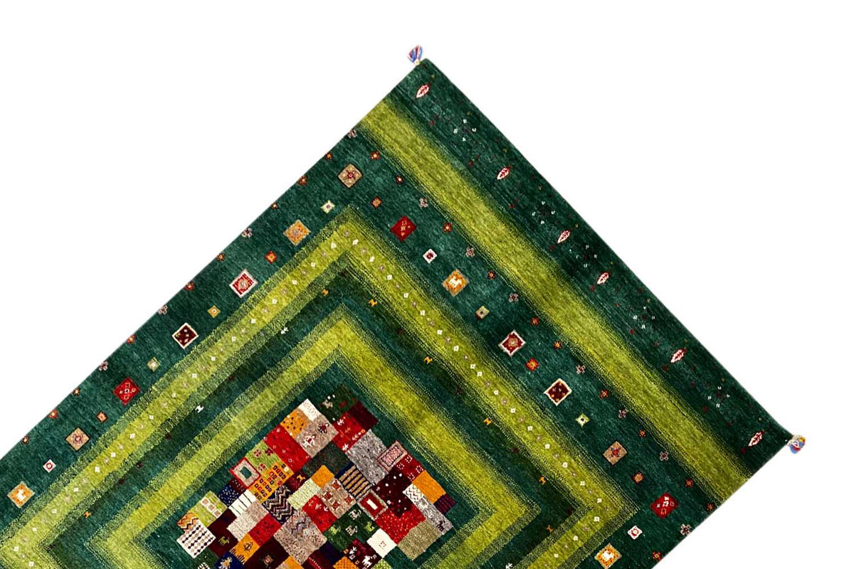 Gabbeh Lori rug corner view with diamond pattern and patchwork medallion
