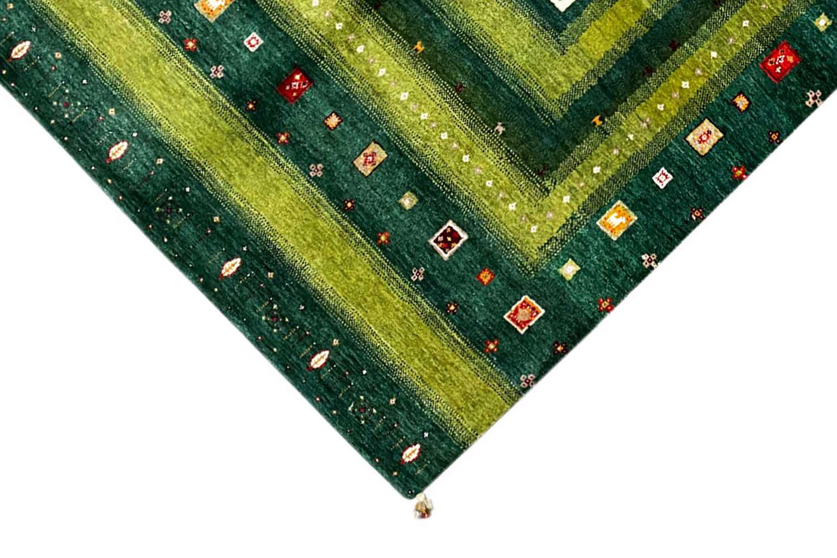 Gabbeh-Lori rug corner detail: green border with small colorful motifs