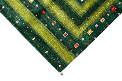 Gabbeh-Lori rug corner detail: green border with small colorful motifs