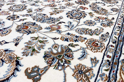Close-up: beige Oriental rug with a detailed floral pattern in blue and brown