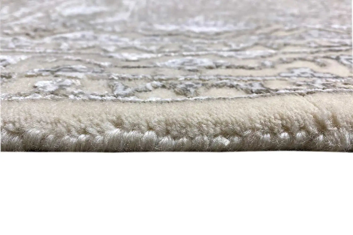 Rug edge with dense pile and light, mottled tones