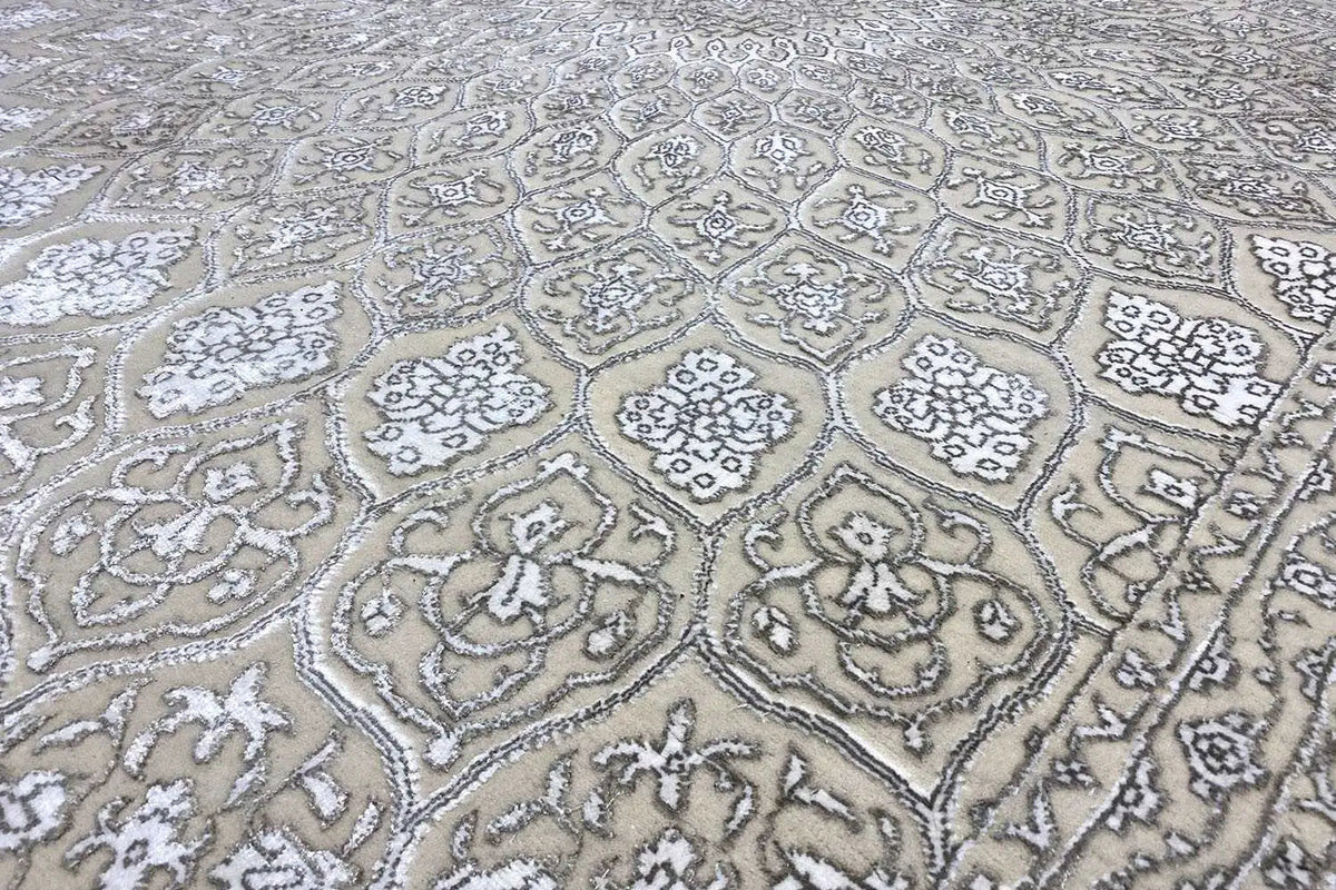 Carpet detail with a light beige-gray ornamental pattern and border