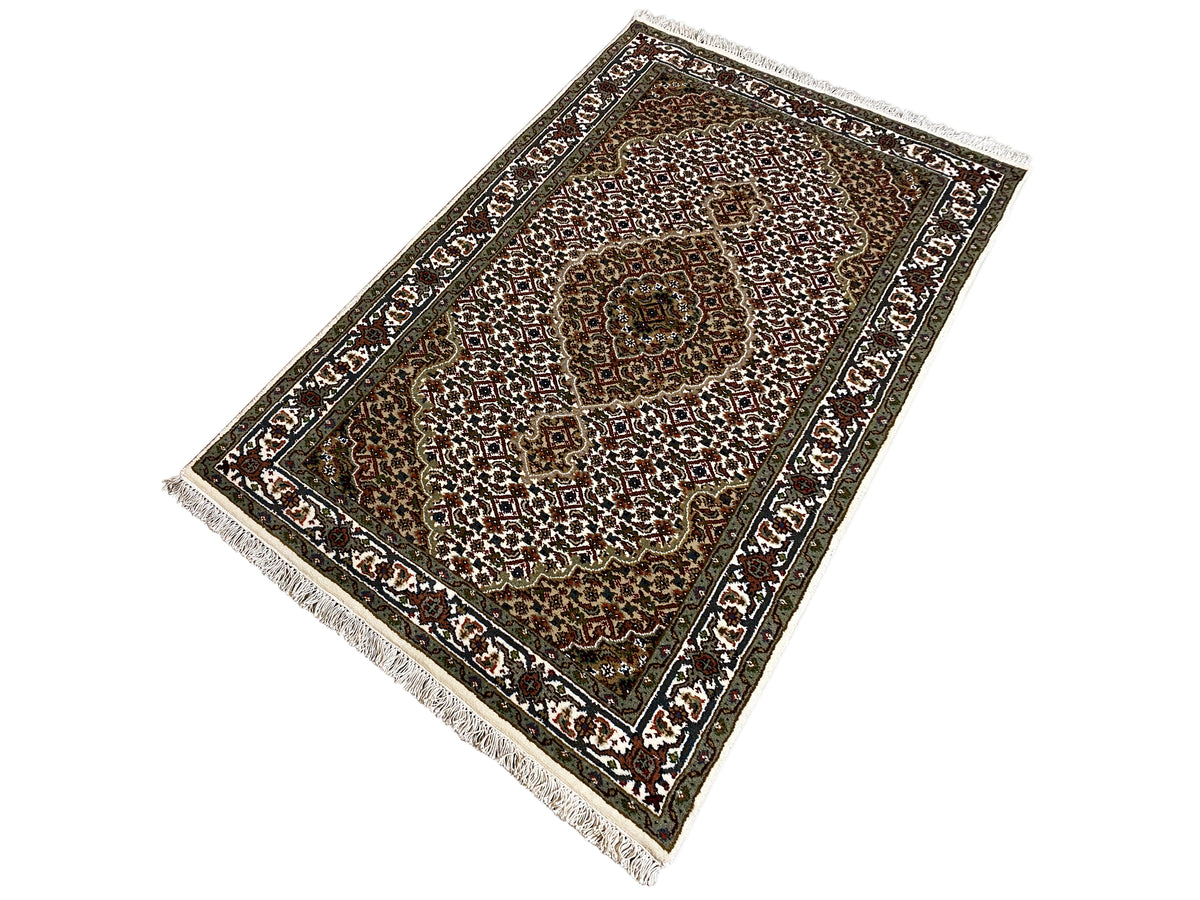 Indo Tabriz rug, rectangular: laid at an angle, brown-green field with ornamental borders