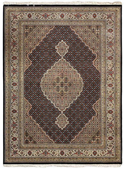 Tabriz-style rug with a symmetrical medallion pattern and fine border bands