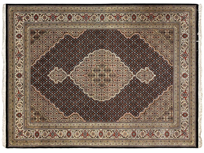 Tabriz-style rug with a large medallion, surrounding border, and ornamental friezes