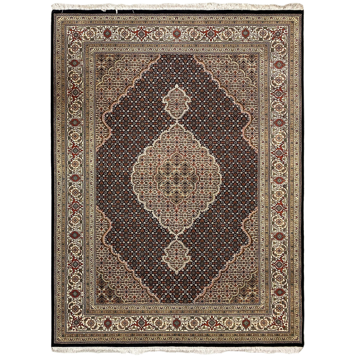 Tabriz-style rug with a central medallion in beige, brown, and dark red