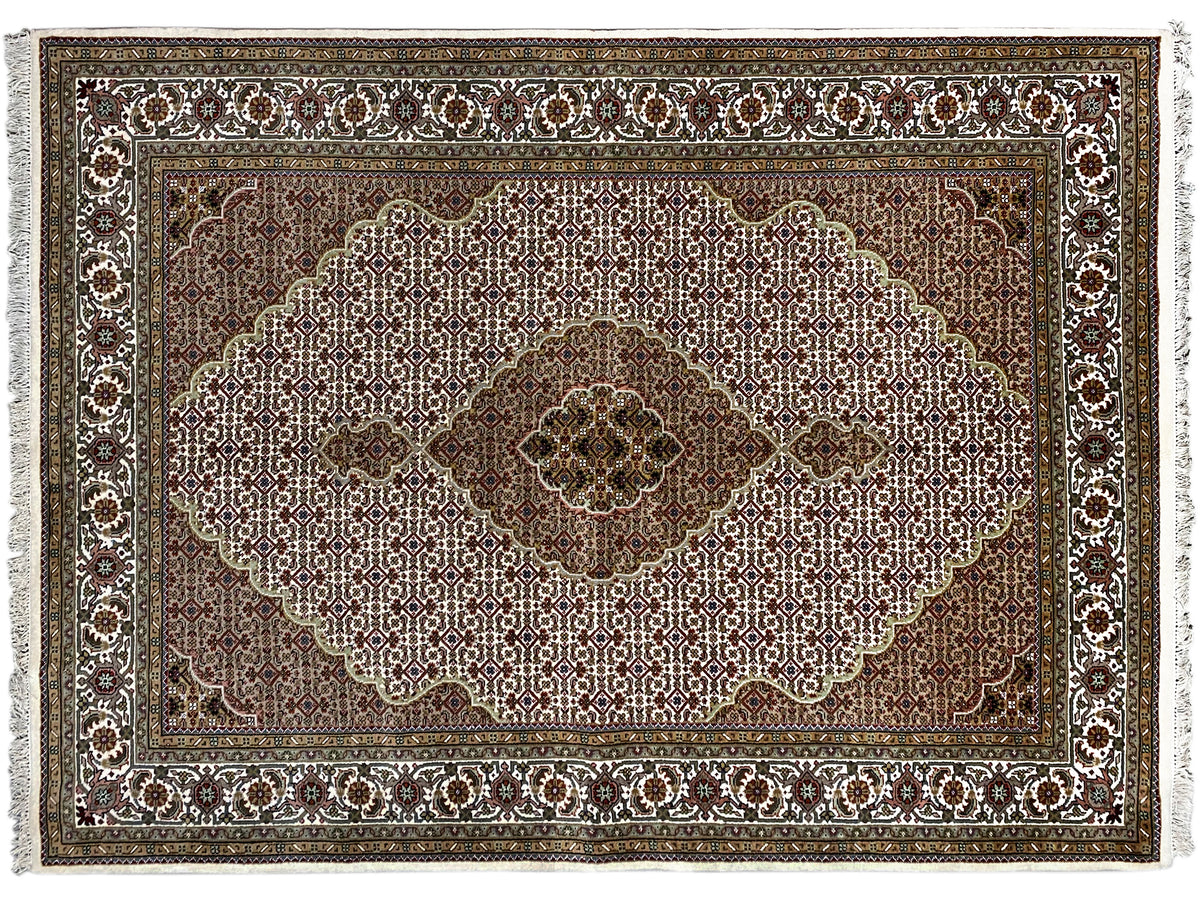 Indo Tabriz rug: Detail of the floral composition with border, brown and light