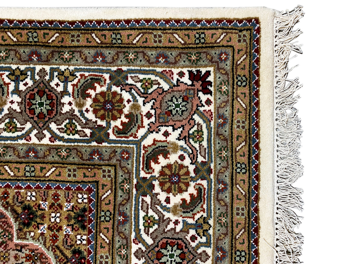 Indo Tabriz rug: corner detail with ornaments and fringes, multicolored pattern