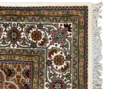 Indo Tabriz rug: corner detail with ornaments and fringes, multicolored pattern
