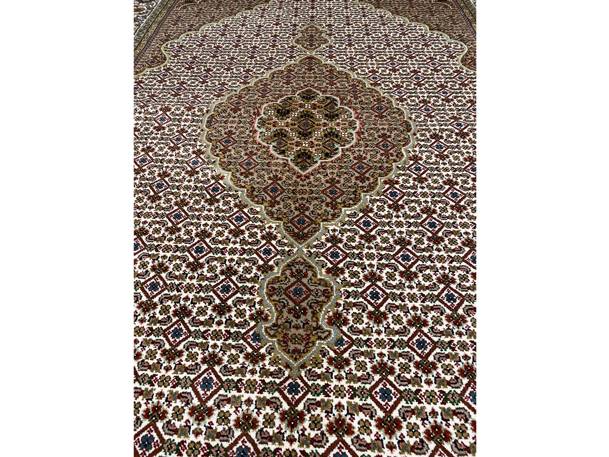 Indo Tabriz rug: Central medallion and small ornaments on a beige-brown background