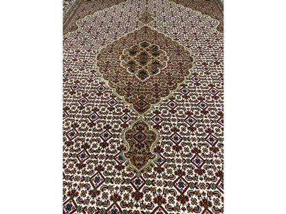 Indo Tabriz rug: Central medallion and small ornaments on a beige-brown background