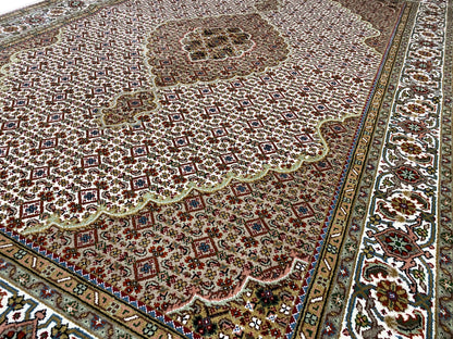 Indo Tabriz rug: ornamental medallion, brown-beige pattern, border trim