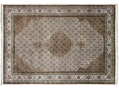 Carpet detail: large, light medallion on a brown field with a decorative border.