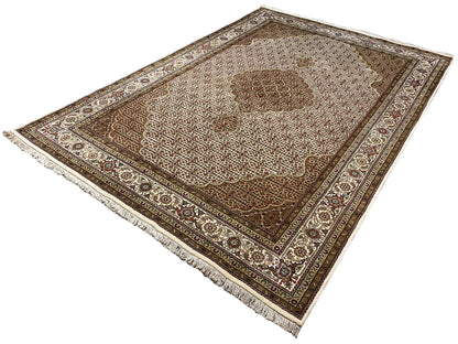 Beige/brown rug with a central ornament, an all-around border, and tassel fringes on the sides.