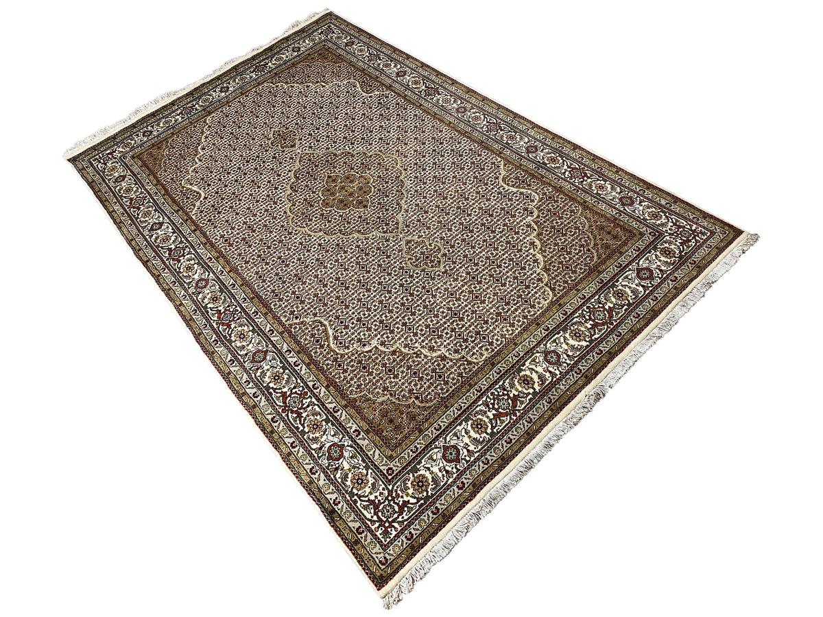 Carpet in an angled view, ornamental border frame, and central floral motif