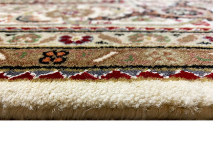 Carpet edge in detail: short pile, multicolored stripe patterns, and light-colored fibers.