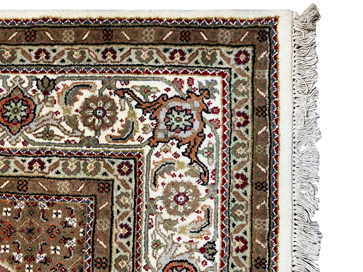Carpet: Detail of a corner with an ornamental band and tassel fringe on the right and bottom.