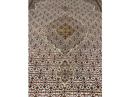 Carpet detail of the medallion, fine micro-ornamental pattern in beige and dark red
