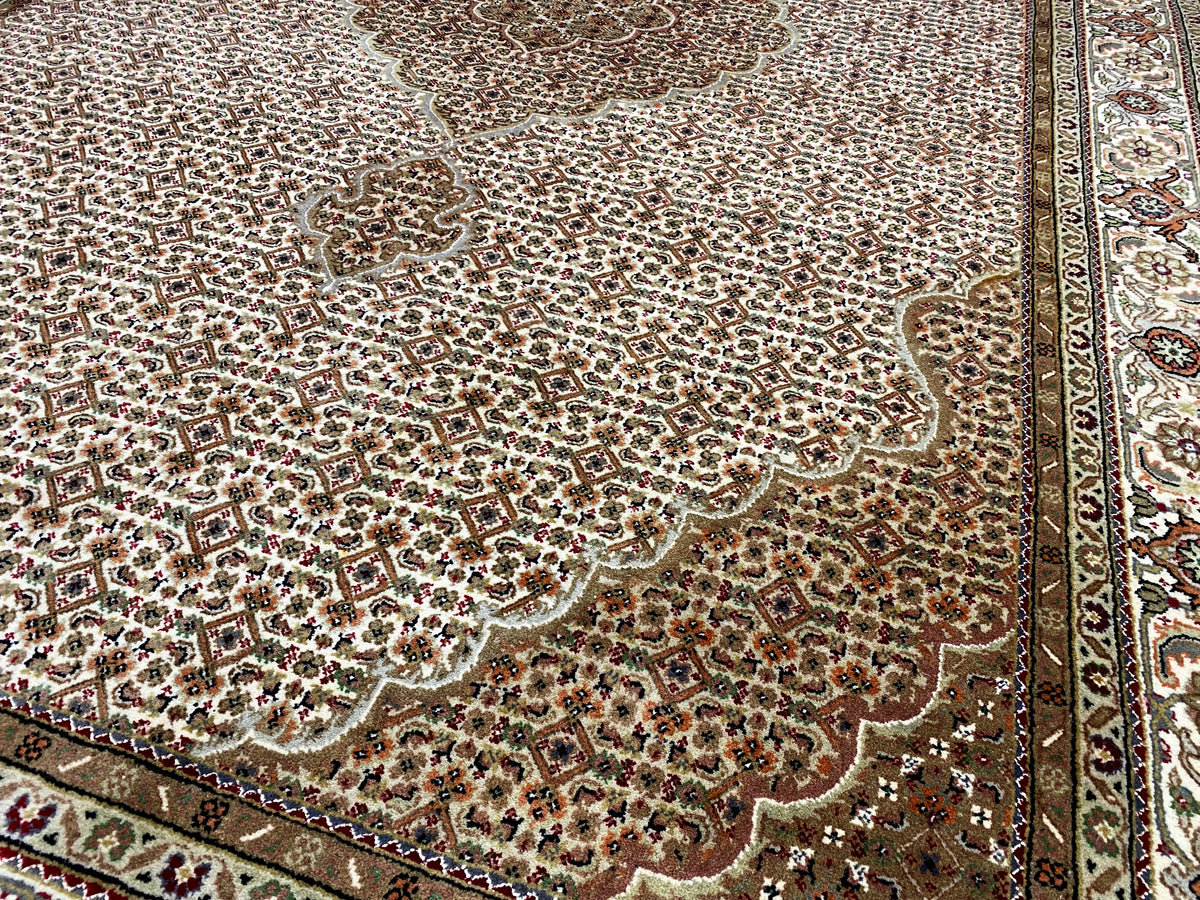Oriental rug with a delicate ornamental pattern in beige, brown, and dark red, bordered